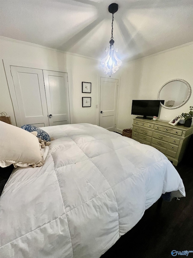 bedroom with ornamental molding and a closet