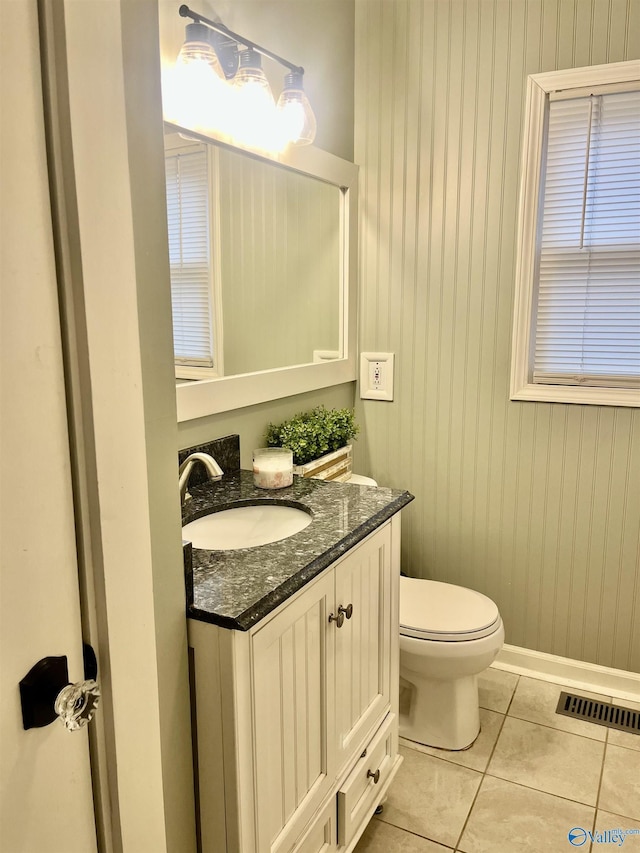 bathroom featuring tile patterned floors, toilet, and vanity