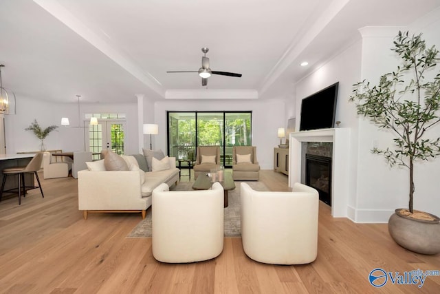 60 Trail Loop Rd, Huntsville, AL 35803 - living area with a raised ceiling, light wood-type flooring, a premium fireplace, and ceiling fan