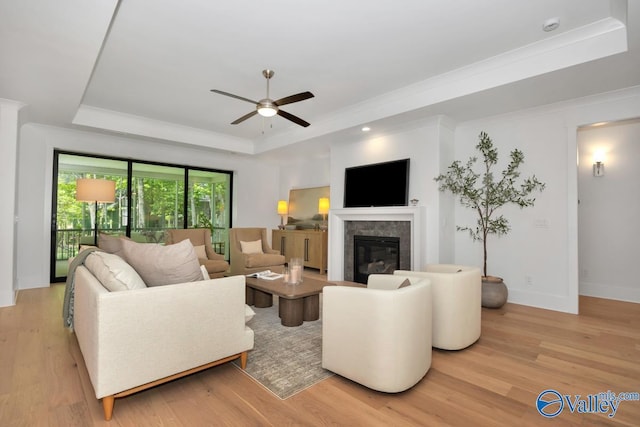 60 Trail Loop Rd, Huntsville, AL 35803 - living room featuring a raised ceiling, light wood-style flooring, ceiling fan, a high end fireplace, and ornamental molding