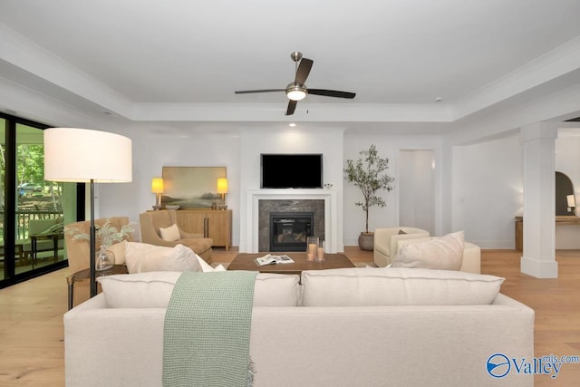 60 Trail Loop Rd, Huntsville, AL 35803 - living room featuring a raised ceiling, a ceiling fan, a glass covered fireplace, wood finished floors, and ornamental molding