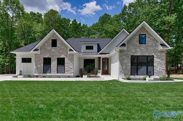 60 Trail Loop Rd, Huntsville, AL 35803 - modern farmhouse style home featuring stone siding, a front yard, board and batten siding, and a standing seam roof
