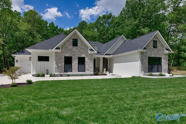 60 Trail Loop Rd, Huntsville, AL 35803 - view of front of house featuring stone siding, a garage, a front yard, and board and batten siding