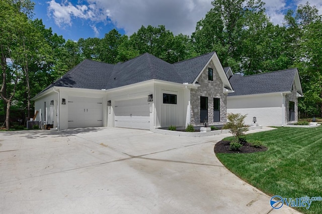 60 Trail Loop Rd, Huntsville, AL 35803 - view of front of property featuring a garage, driveway, a front lawn, roof with shingles, and stone siding