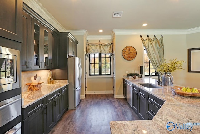 60 Trail Loop Rd, Huntsville, AL 35803 - kitchen with appliances with stainless steel finishes, light stone counters, glass insert cabinets, ornamental molding, and recessed lighting