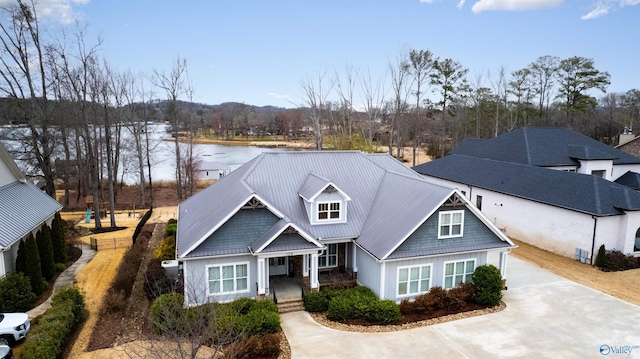 view of front facade featuring metal roof and a water view