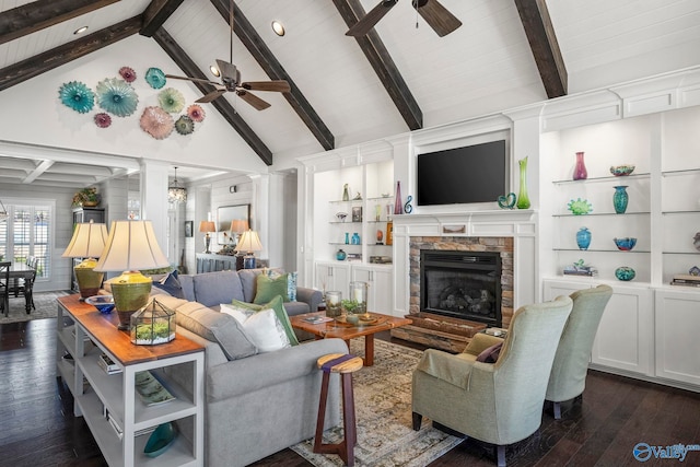 living area featuring dark wood-type flooring, built in features, a fireplace, and ceiling fan