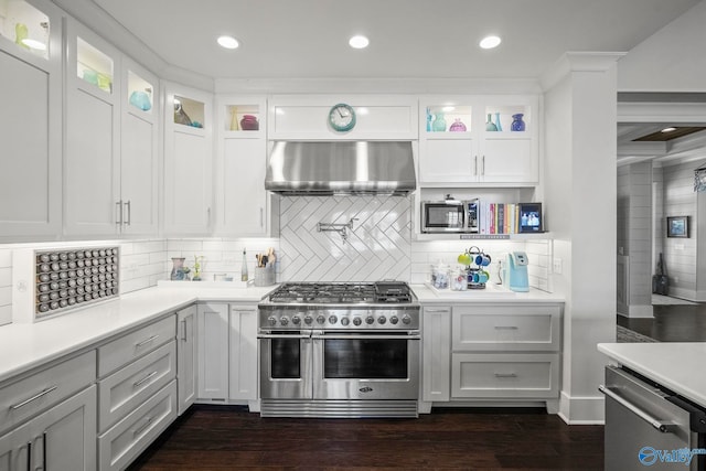 kitchen featuring white cabinetry, extractor fan, appliances with stainless steel finishes, and light countertops