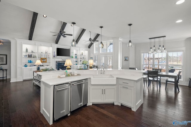 kitchen with vaulted ceiling with beams, a sink, light countertops, dishwasher, and open floor plan