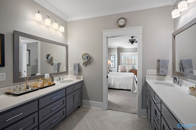 ensuite bathroom with ornamental molding, ensuite bath, baseboards, ceiling fan, and vanity