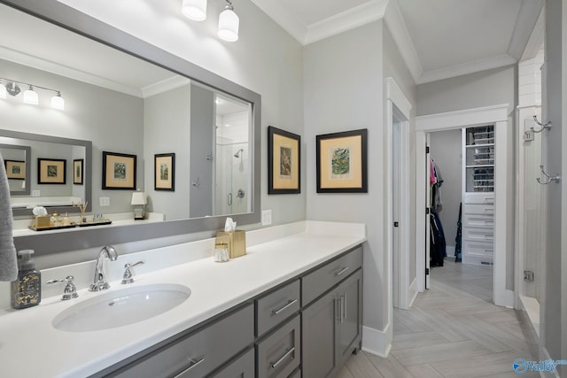 full bathroom with vanity, baseboards, ornamental molding, a shower stall, and a spacious closet