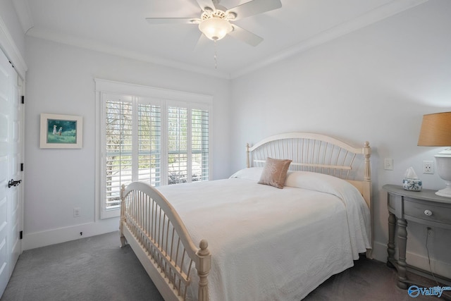 carpeted bedroom featuring ornamental molding, baseboards, and ceiling fan