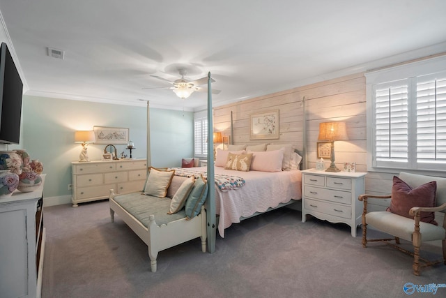 carpeted bedroom featuring visible vents, ceiling fan, and crown molding