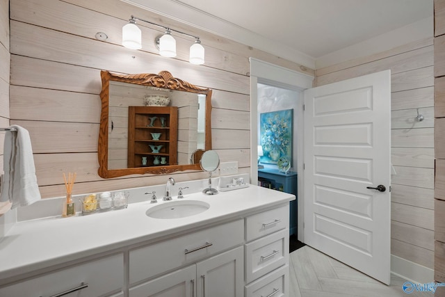 bathroom with vanity and wood walls