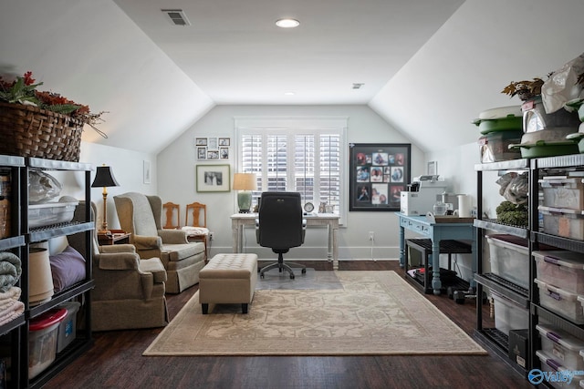 office space with visible vents, lofted ceiling, baseboards, and wood finished floors