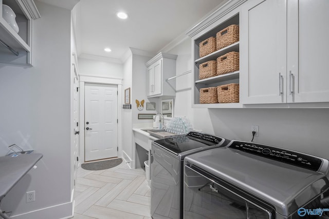 laundry area featuring baseboards, separate washer and dryer, recessed lighting, cabinet space, and ornamental molding