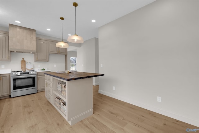 kitchen with wood counters, light wood-type flooring, custom range hood, a kitchen island, and stainless steel range with electric cooktop