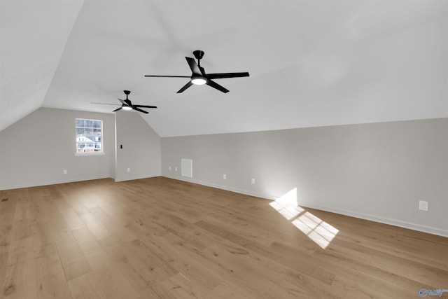 additional living space with ceiling fan, lofted ceiling, and light hardwood / wood-style flooring