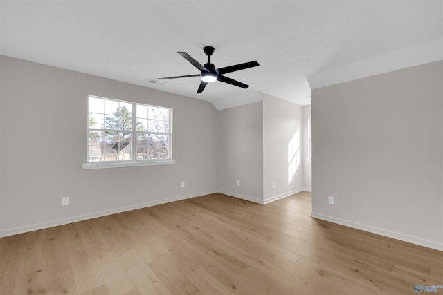 unfurnished room featuring ceiling fan, vaulted ceiling, and light hardwood / wood-style flooring