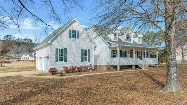 cape cod home featuring covered porch, a garage, and a front yard