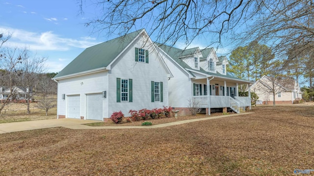 view of front facade with a front lawn, a porch, and a garage