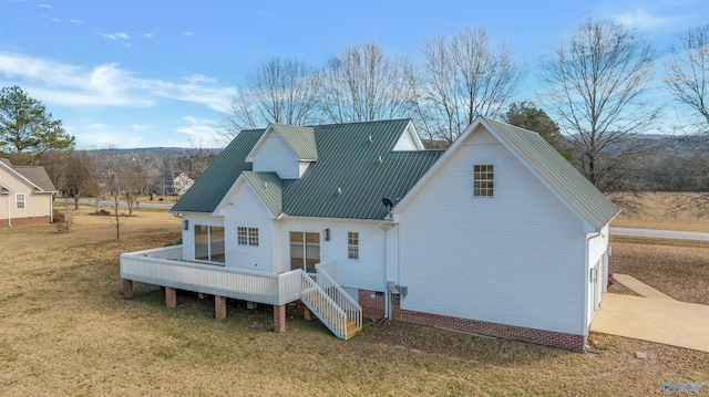 rear view of property with a yard and a wooden deck