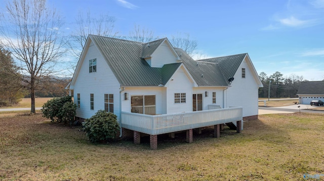 back of property with a lawn and a deck