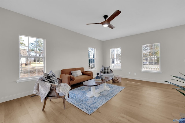 living room featuring light hardwood / wood-style floors and ceiling fan