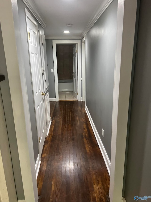 hall with dark hardwood / wood-style flooring and ornamental molding