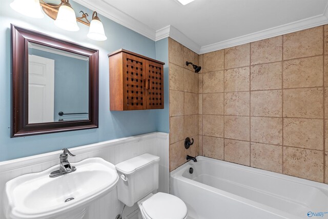 full bathroom with sink, toilet, crown molding, and tiled shower / bath