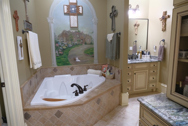 bathroom with tile patterned flooring, vanity, and a relaxing tiled tub