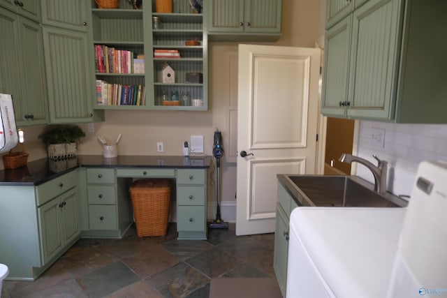 kitchen featuring tasteful backsplash, sink, washer and clothes dryer, and green cabinetry