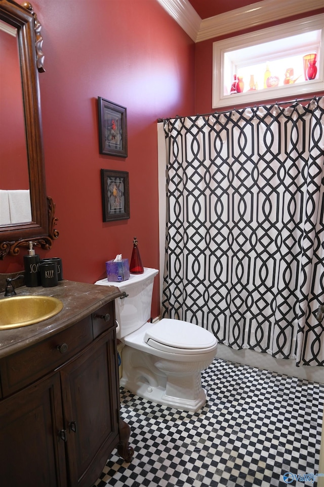 bathroom with vanity, toilet, and crown molding