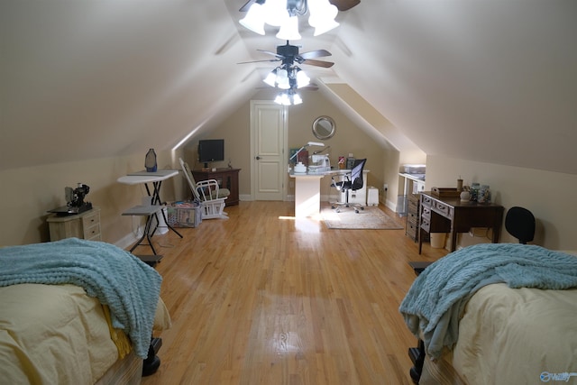 bedroom featuring ceiling fan, light wood-type flooring, and vaulted ceiling