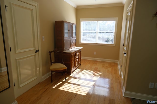 interior space with light hardwood / wood-style flooring and ornamental molding