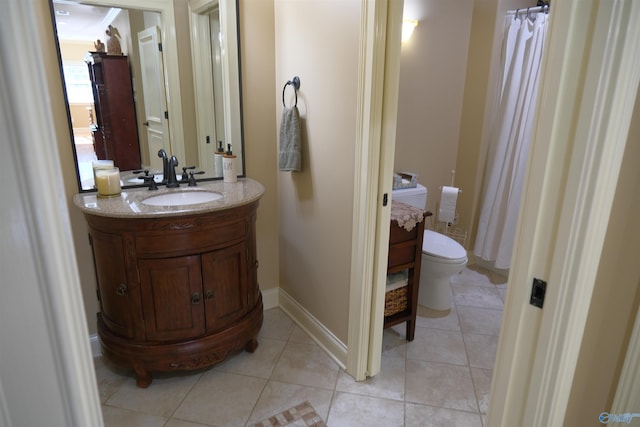 bathroom with tile patterned floors, vanity, and toilet