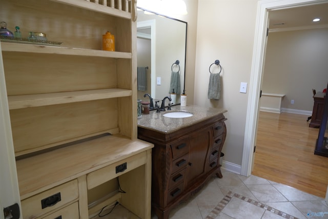 bathroom featuring vanity, hardwood / wood-style flooring, and ornamental molding