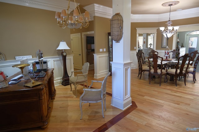 dining space featuring light hardwood / wood-style floors, ornamental molding, a wealth of natural light, and ornate columns