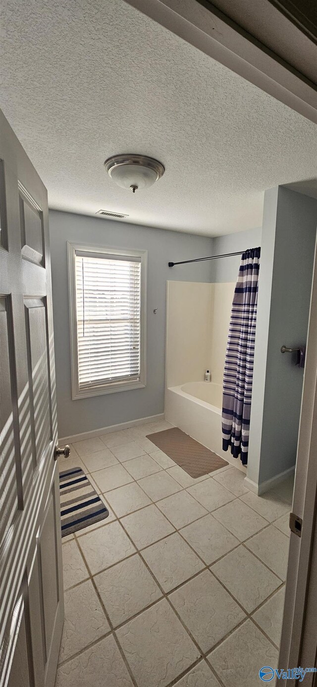 kitchen with stainless steel fridge, ornamental molding, sink, light tile patterned floors, and decorative light fixtures