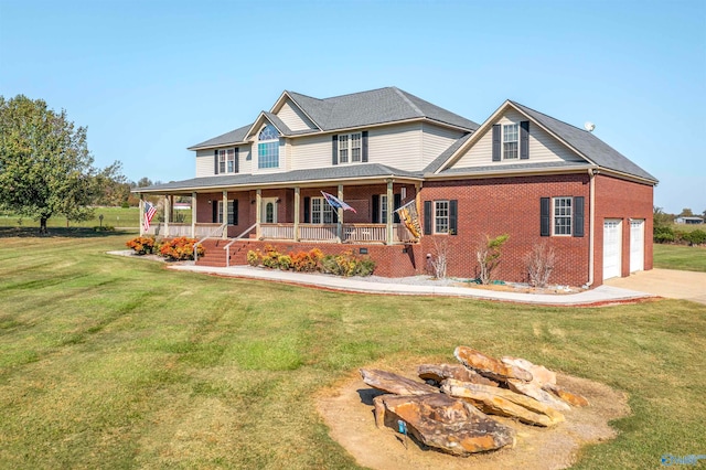 view of front facade with covered porch, a front yard, and a garage