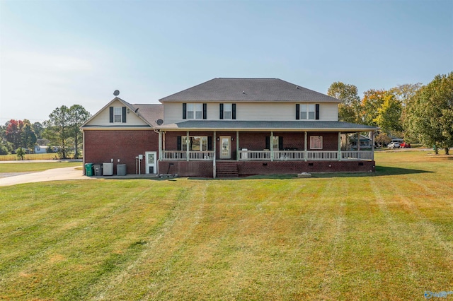 rear view of house featuring a porch, a yard, and central AC