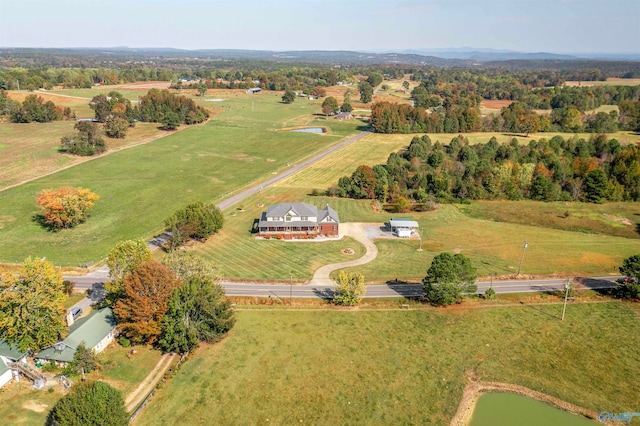 birds eye view of property with a rural view