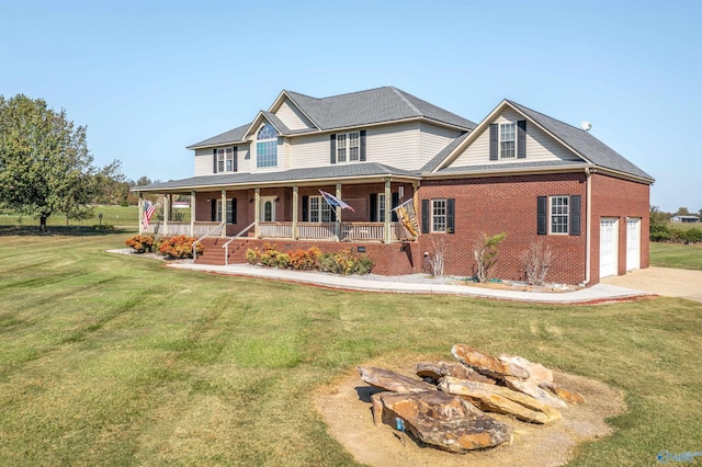 view of front of property featuring a garage, a front yard, and a porch