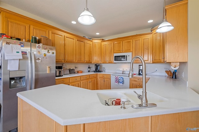 kitchen with pendant lighting, kitchen peninsula, and appliances with stainless steel finishes