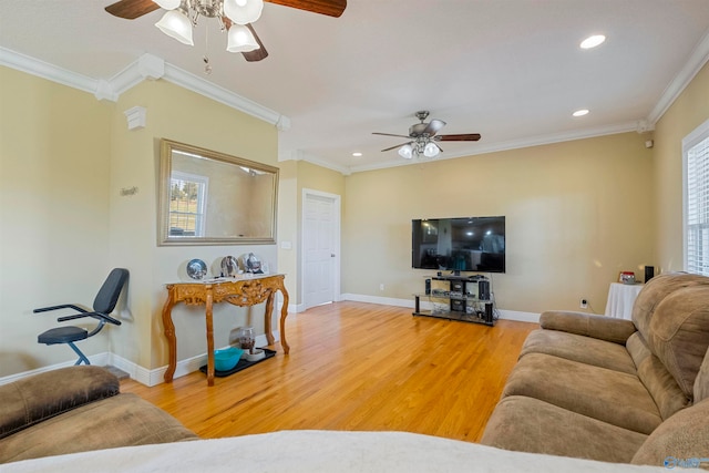 living room featuring a healthy amount of sunlight, crown molding, and wood-type flooring