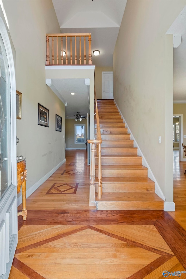 entrance foyer with ceiling fan, hardwood / wood-style floors, and crown molding