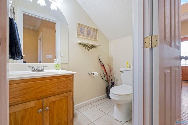 bathroom featuring tile patterned floors, vanity, toilet, and lofted ceiling