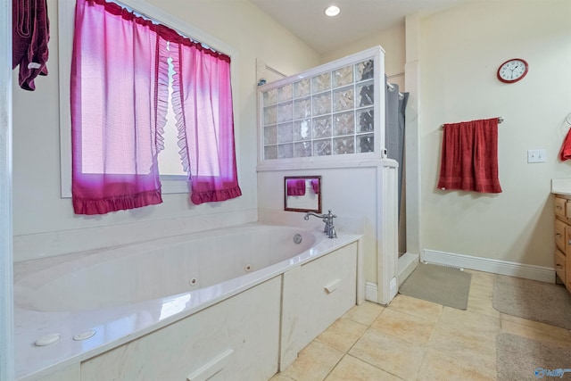 bathroom featuring tile patterned floors, vanity, and shower with separate bathtub