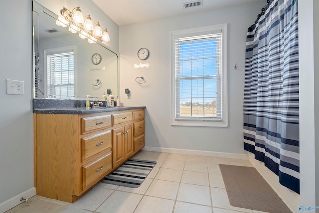 bathroom with tile patterned flooring and vanity