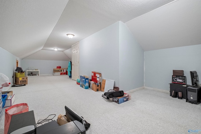 rec room with carpet flooring, a textured ceiling, and vaulted ceiling